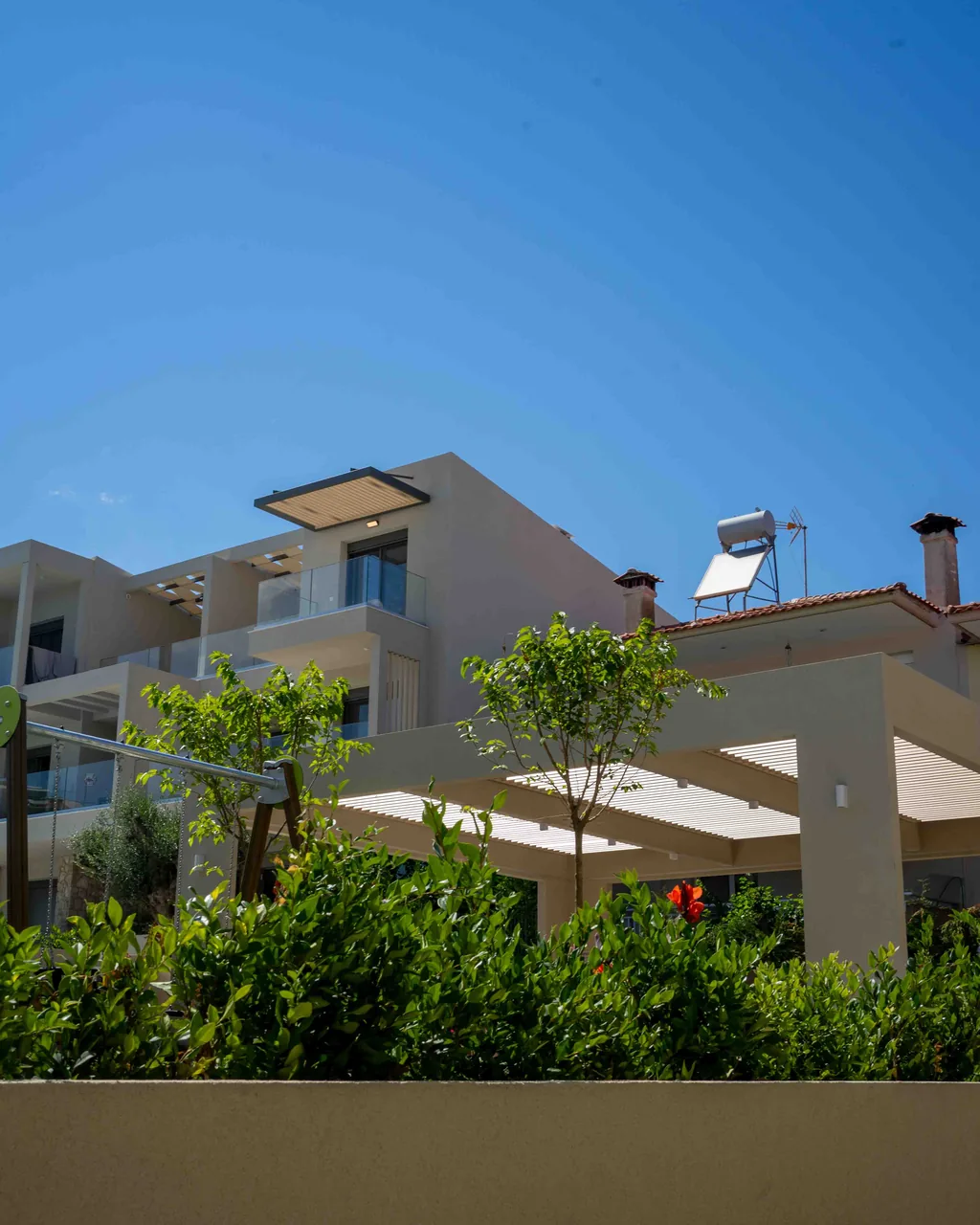 Building at the Orphia complex with pergola and Mediterranean planting