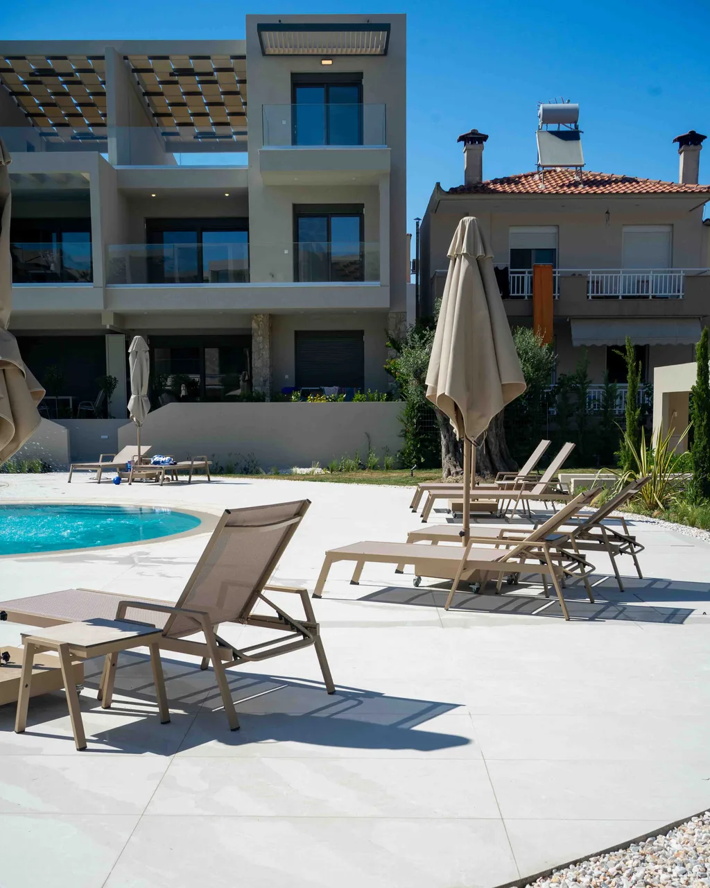 Pool terrace at the Orphia complex with sun loungers and parasols
