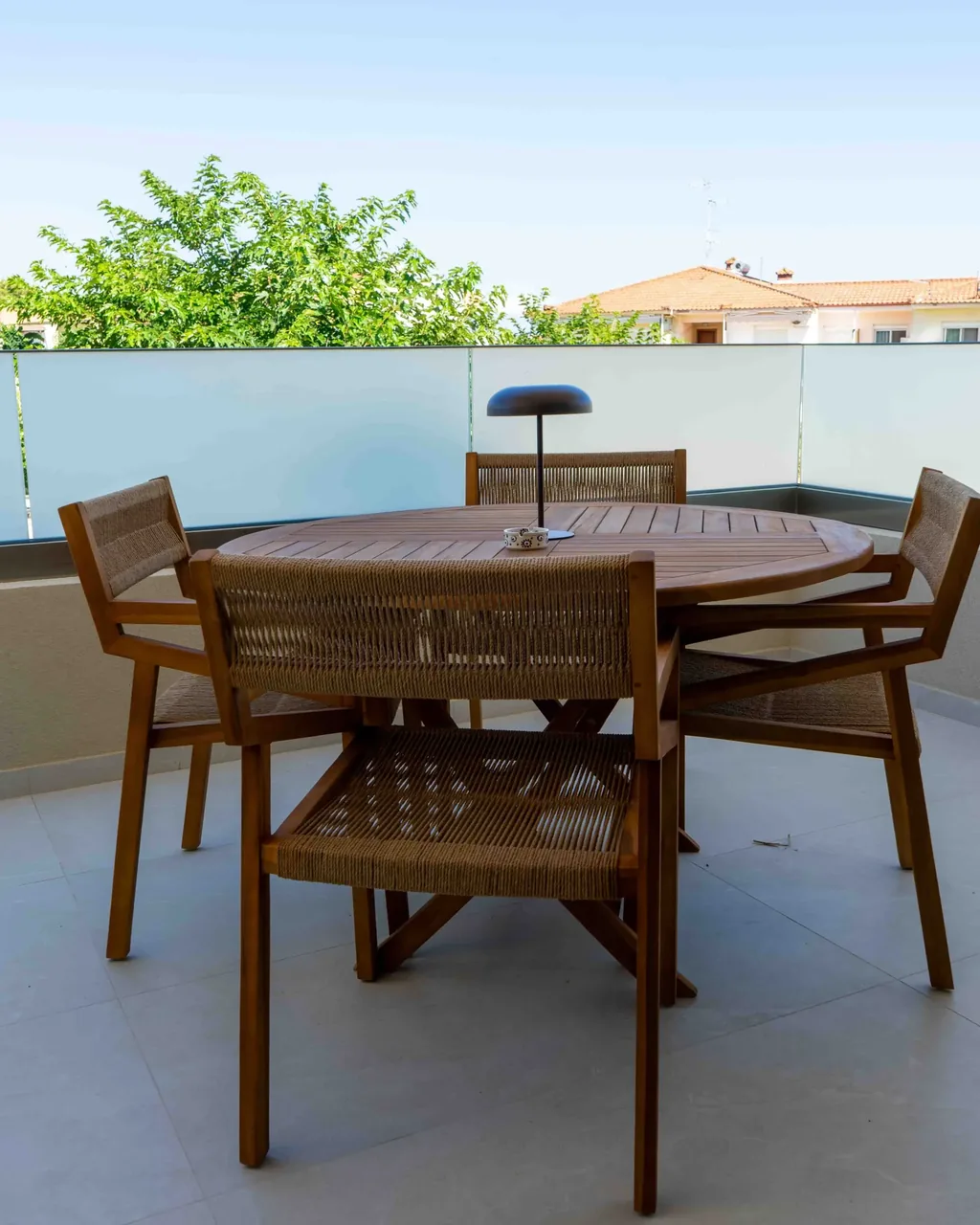 Private terrace with a dining table for four at the Orphia apartment