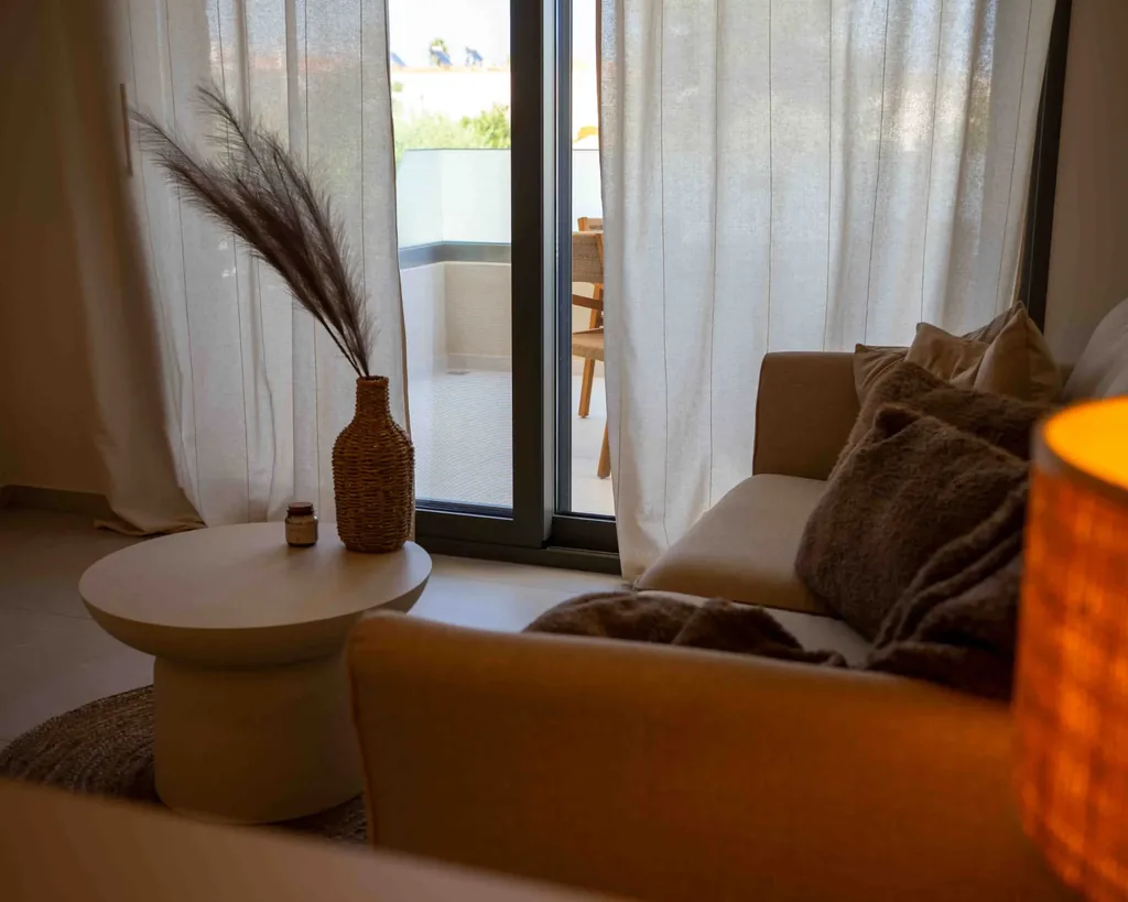 Sofa bed by the window in the living area of the Orphia apartment